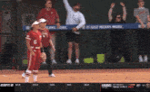 a woman stands in front of an espn 2 screen