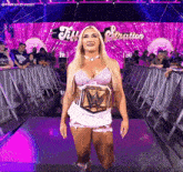 a woman in a wrestling outfit is walking down a ramp with the word stratton on the wall behind her