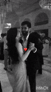 a black and white photo of a man and a woman dancing with the words inshot at the bottom