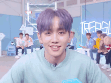 a boy with purple hair is smiling in front of a sign that says ' treasure '