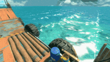 a video game shows a boat in the ocean with a blue barrel in the foreground