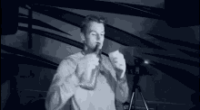 a man smoking a cigarette in front of a camera