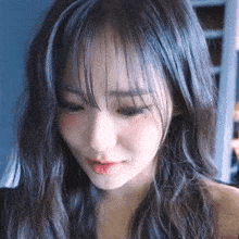 a close up of a woman 's face with bangs