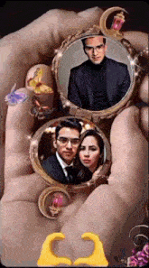 a person is holding a locket with two pictures of a man and woman inside of it