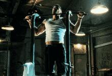 a man is doing a pull up in a gym