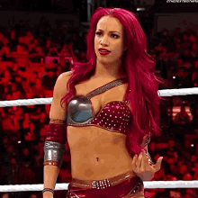 a woman with red hair is standing in a wrestling ring with the hashtag #thenextbigthing