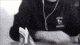 a black and white photo of a person wearing headphones and a shirt with the letter e on it