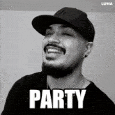 a black and white photo of a man wearing a ny hat with the word party below him