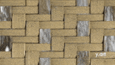 a close up of a wicker weave with the words y.art below