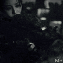 a black and white photo of a woman with the letters ms on the bottom right
