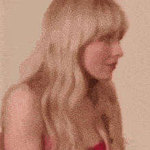 a close up of a woman 's face with blonde hair and bangs .