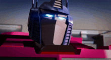 a close up of a robot 's face with blue eyes