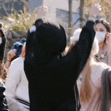 a group of people wearing face masks are dancing