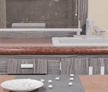 a bowl of popcorn is on a table in front of a sink .