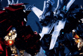 a red robot and a black robot are standing next to each other in a dark room