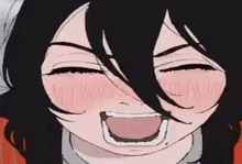 a close up of a person 's face with a laughing expression .