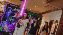 a woman is holding a purple light saber in front of a sign that says ' ao ' on it