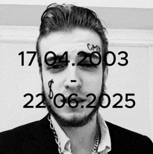 a black and white photo of a man with a tattoo on his face