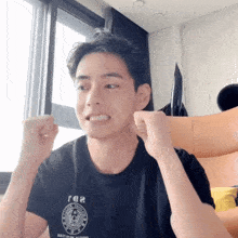a man wearing a black t-shirt that says 102
