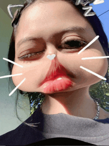 a girl with a cat ear on her head making a cat face