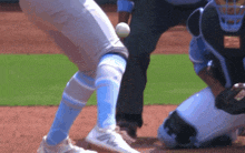 a baseball player wearing blue and white socks is about to throw a baseball
