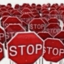 a bunch of stop signs are lined up in a row .