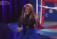 a woman in a red dress is dancing in a crowd