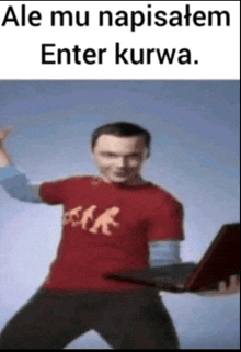 a man in a red shirt is holding a laptop with the words ale mu napisatem enter kurwa below him