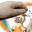 a cartoon character with wings is being held by a hand