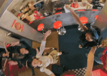 a group of people are dancing in a diner with a sign that says ' 101 ' on it