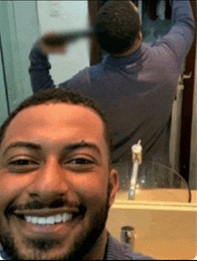 a man taking a selfie in front of a mirror