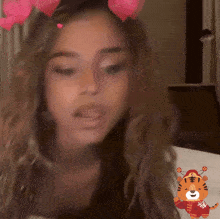 a woman wearing a tiger sticker on her face