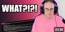 a man wearing headphones and a pink shirt says what ? ! ?