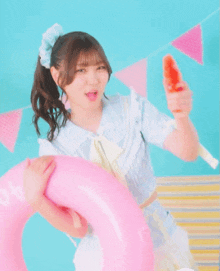 a girl in a blue dress is holding a pink life preserver that says ao
