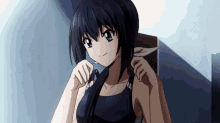 a girl with long black hair and blue eyes is adjusting her hair