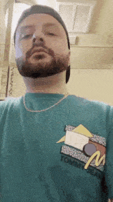 a man with a beard wearing a tommy jeans t-shirt
