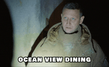 a man in a hooded jacket with the words ocean view dining above him