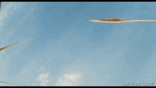 a gif from gifrun.com shows a man talking on a phone