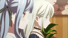 two anime girls are standing next to each other looking at something