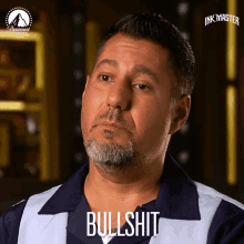 a man with a beard and a shirt that says bullshit on it