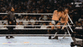 two wrestlers in a wrestling ring with peacock on the bottom right