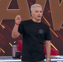 a man wearing a black shirt that says " welcome to the world "