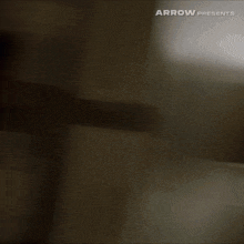 arrow presents a blurred image of a person walking down stairs