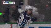 a hockey player wearing a number 55 jersey