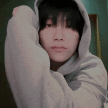 a close up of a person wearing a white hoodie with a hood