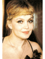 a woman wearing a braided headband and earrings