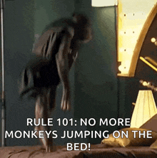 a person is jumping on a bed with the caption rule 101 : no more monkeys jumping on the bed !