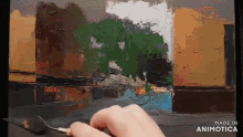 a person is painting a landscape with a spatula and the words made in animotica are on the bottom