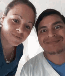 a man and a woman are smiling for the camera