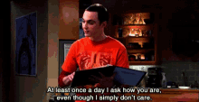 a man in a red shirt is reading a book and says at least once a day